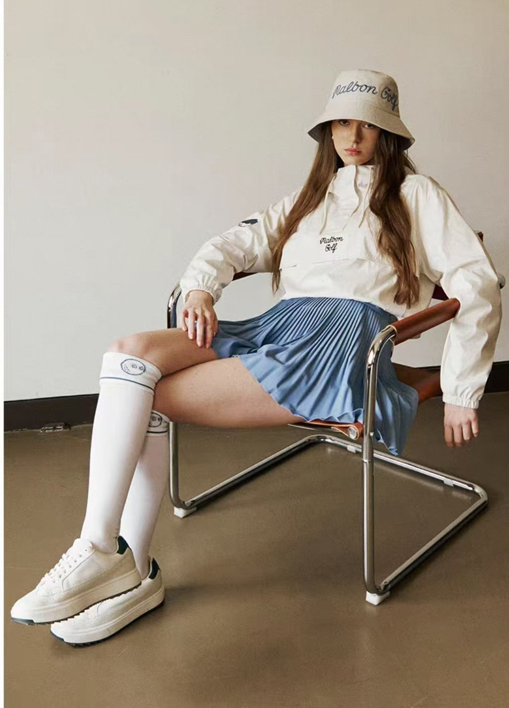 Model outfit with blue Malbon pleated golf skort
