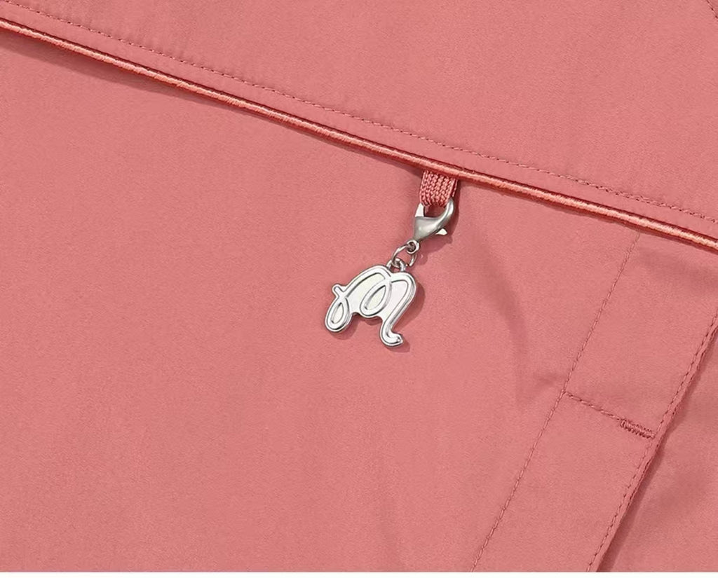 Pink Malbon golf jacket zipper charm detail